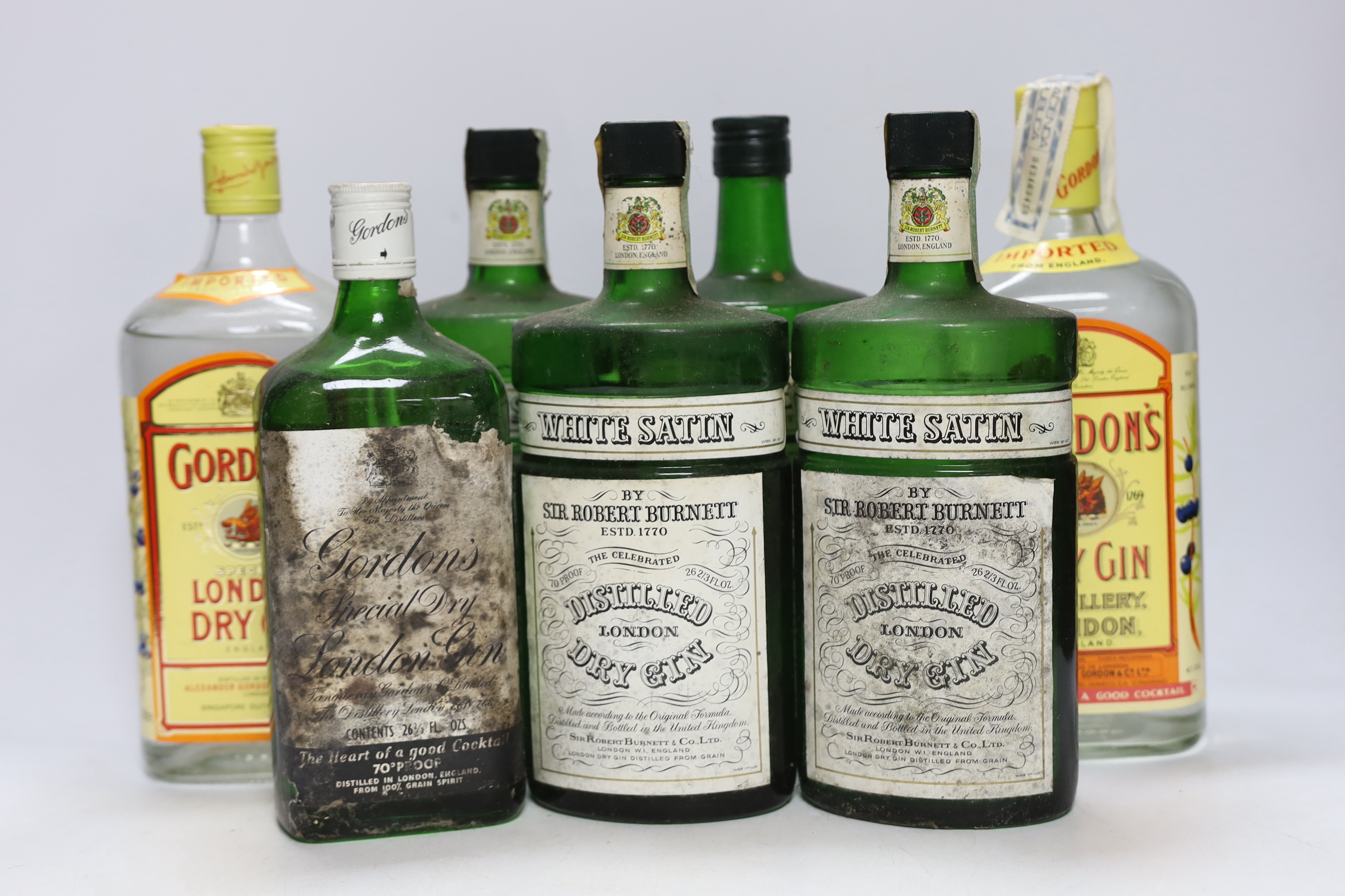 Eight and a half bottles of gin; Gordons, White Satin and Burnetts